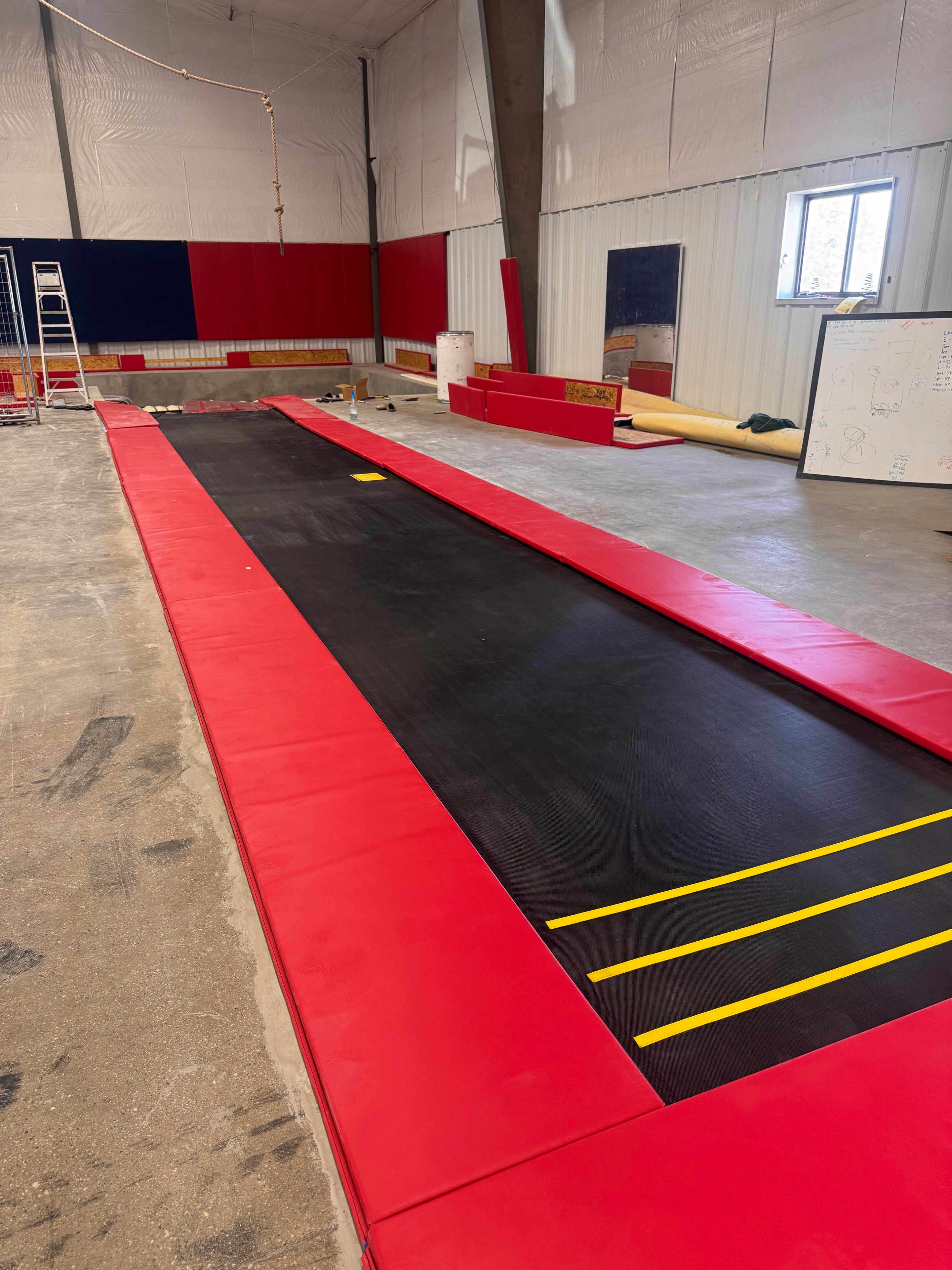 Completed inground Tumble Trak surface with red mats